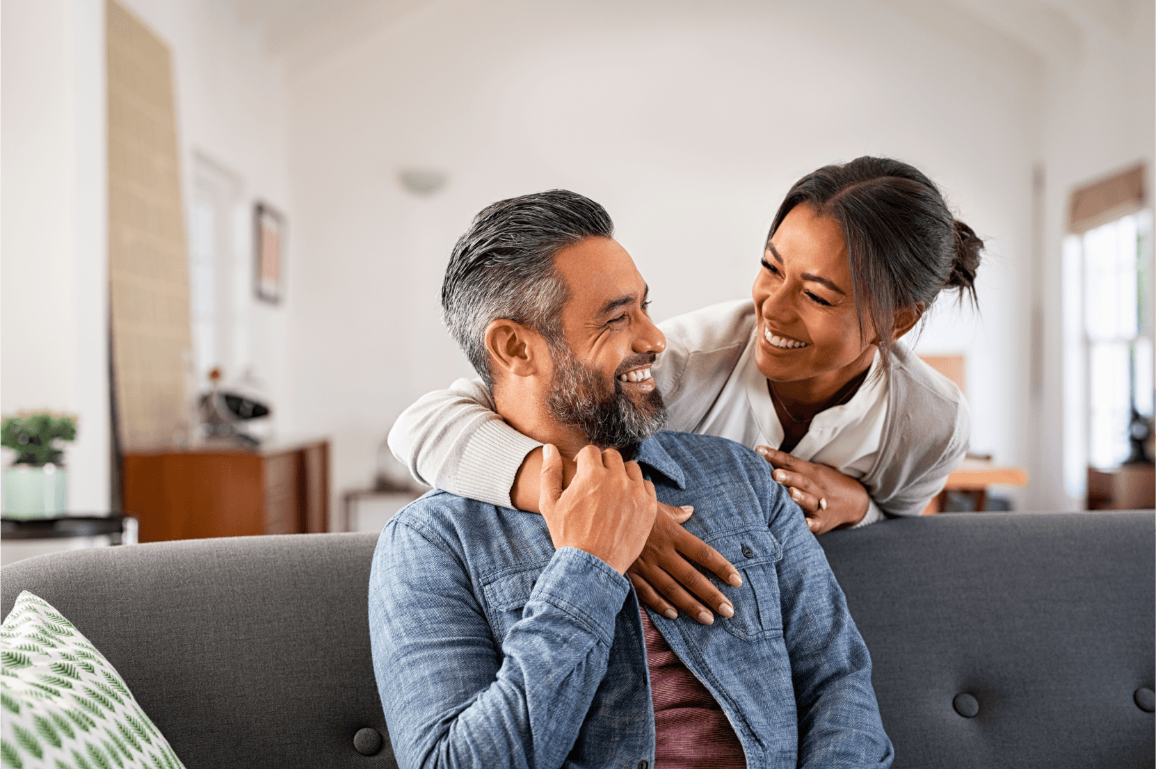 Couple laughing by the couch